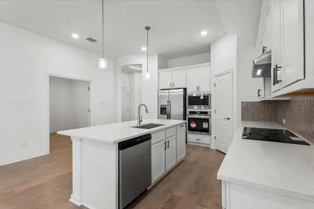 a kitchen with a sink stove and refrigerator