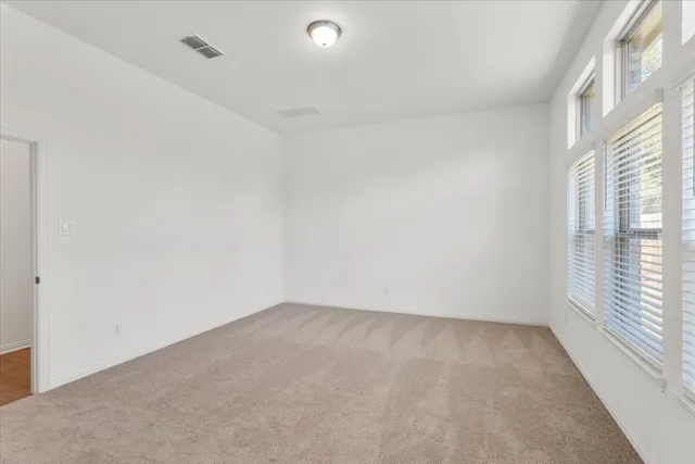 an empty room with windows and closet