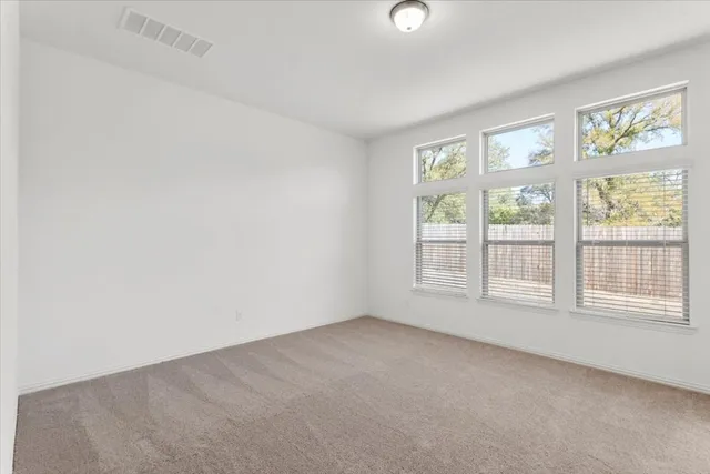 a bathroom with double vanity sinks and a shower