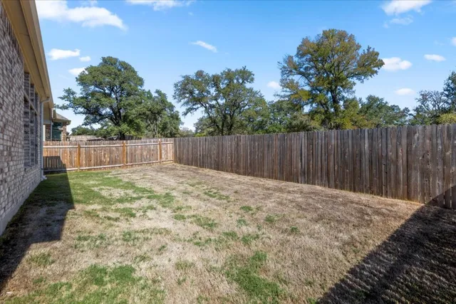 a backyard of a house with lots of green space