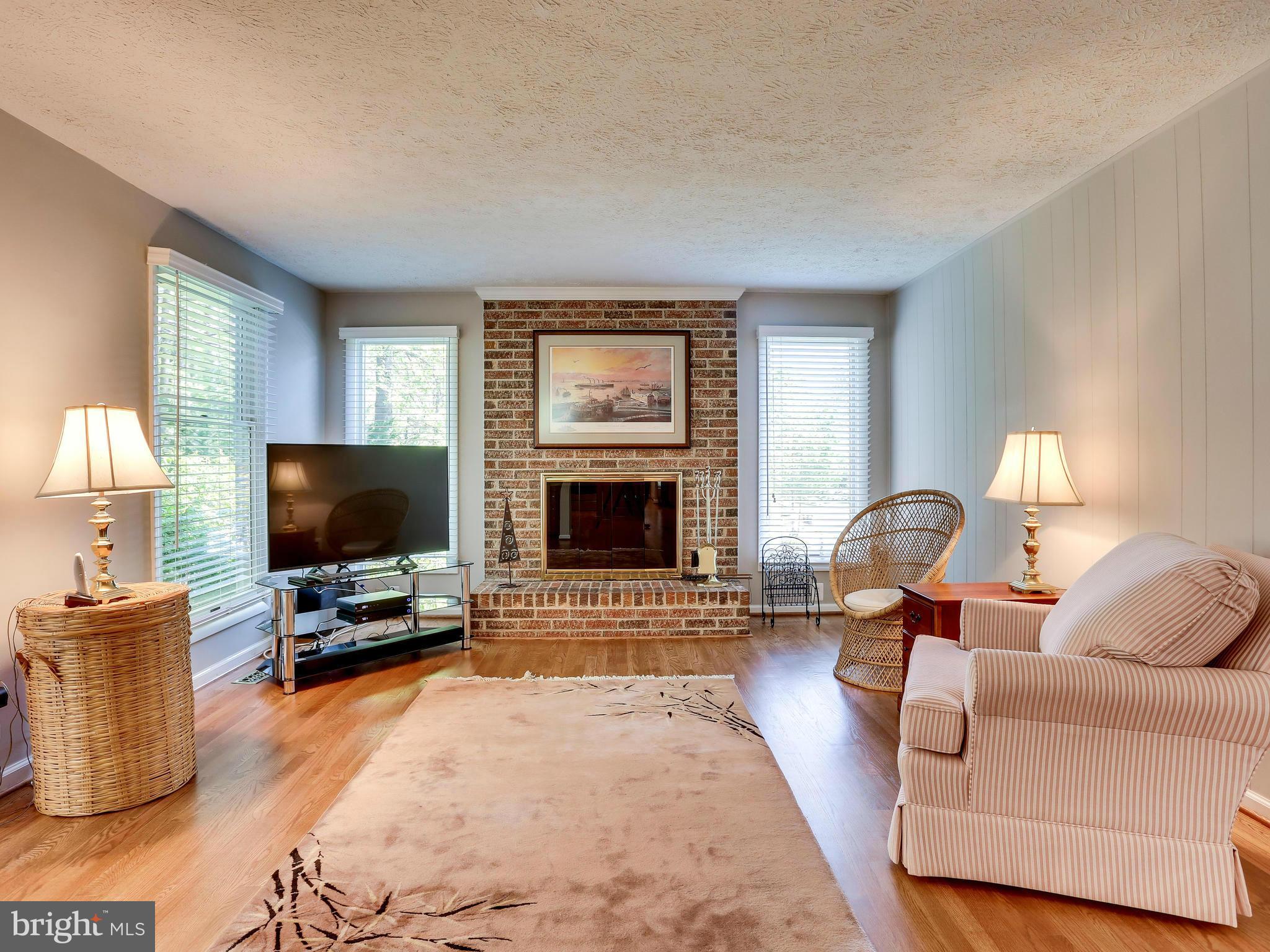7569 Vogels Way Springfield, VA 22153 - Photo 12 of 28 a living room with furniture and a flat screen tv