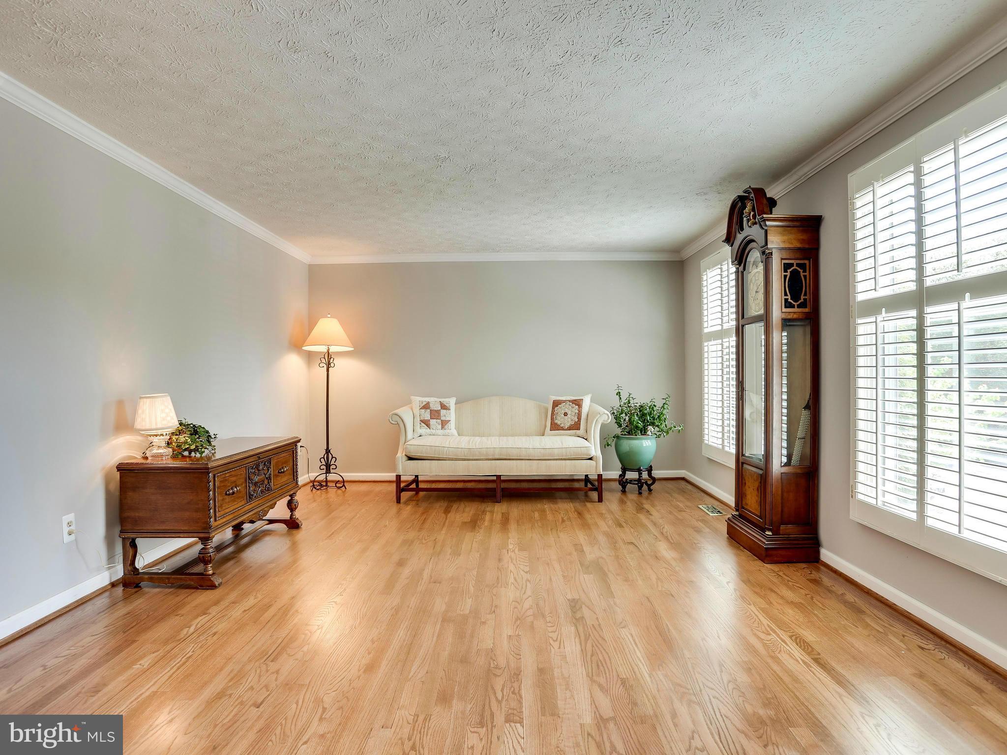 7569 Vogels Way Springfield, VA 22153 - Photo 14 of 28 a living room with furniture and a wooden floor