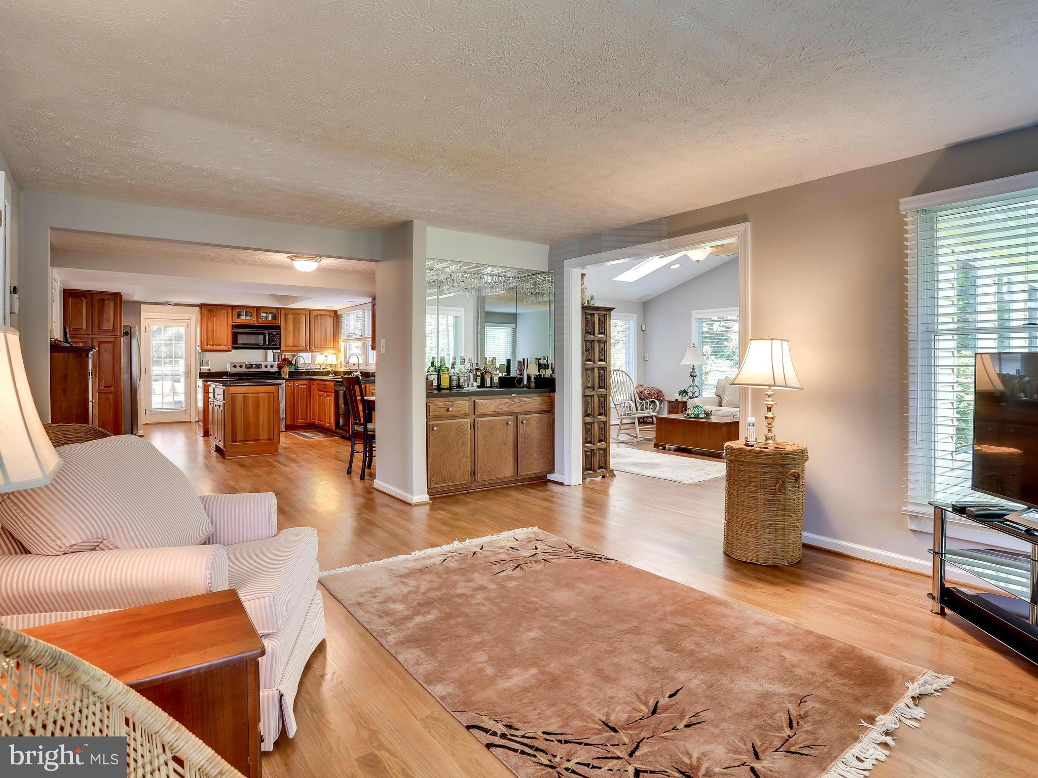 7569 Vogels Way Springfield, VA 22153 - Photo 15 of 28 a living room with furniture and a view of kitchen