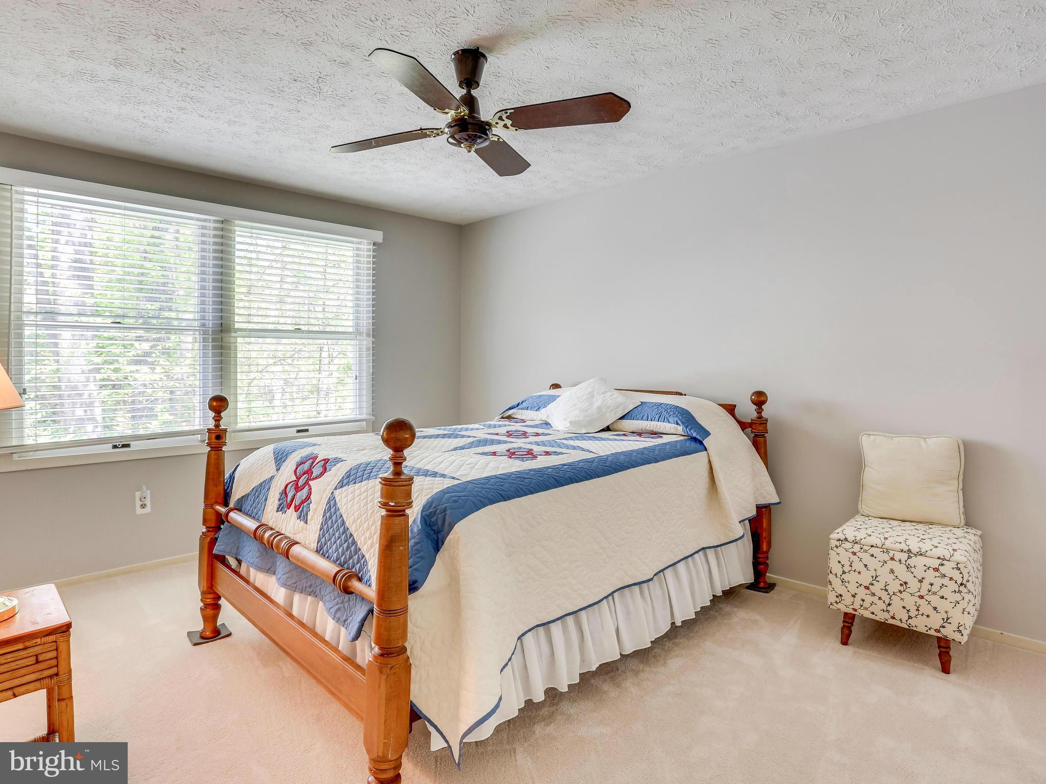 7569 Vogels Way Springfield, VA 22153 - Photo 19 of 28 a bedroom with a bed and a couch