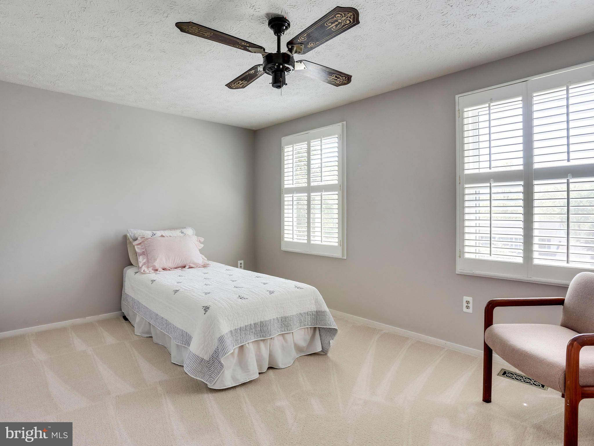 7569 Vogels Way Springfield, VA 22153 - Photo 20 of 28 a bedroom with a bed a couch and a large window