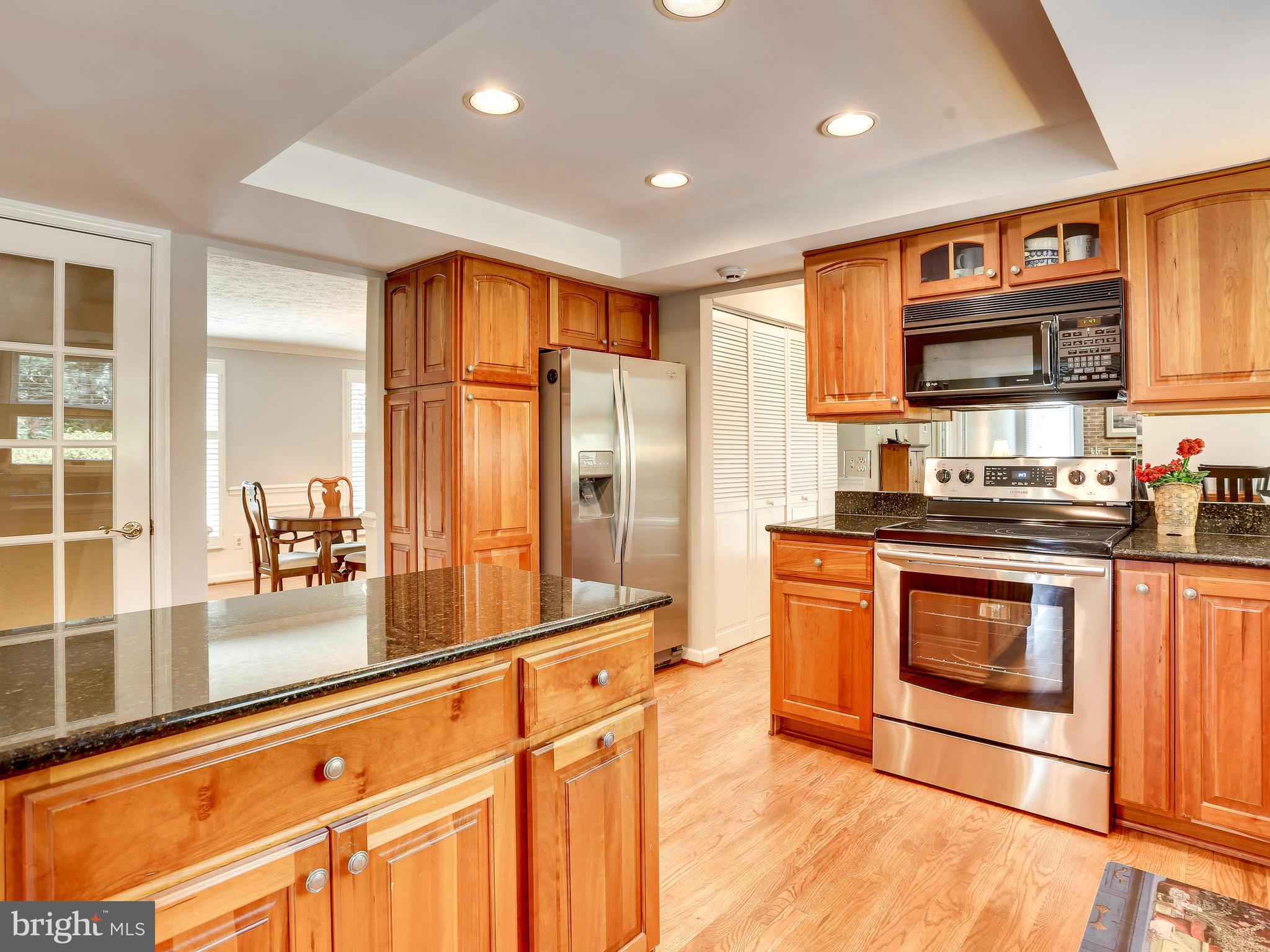 7569 Vogels Way Springfield, VA 22153 - Photo 3 of 28 a kitchen with stainless steel appliances granite countertop a stove a sink and a refrigerator