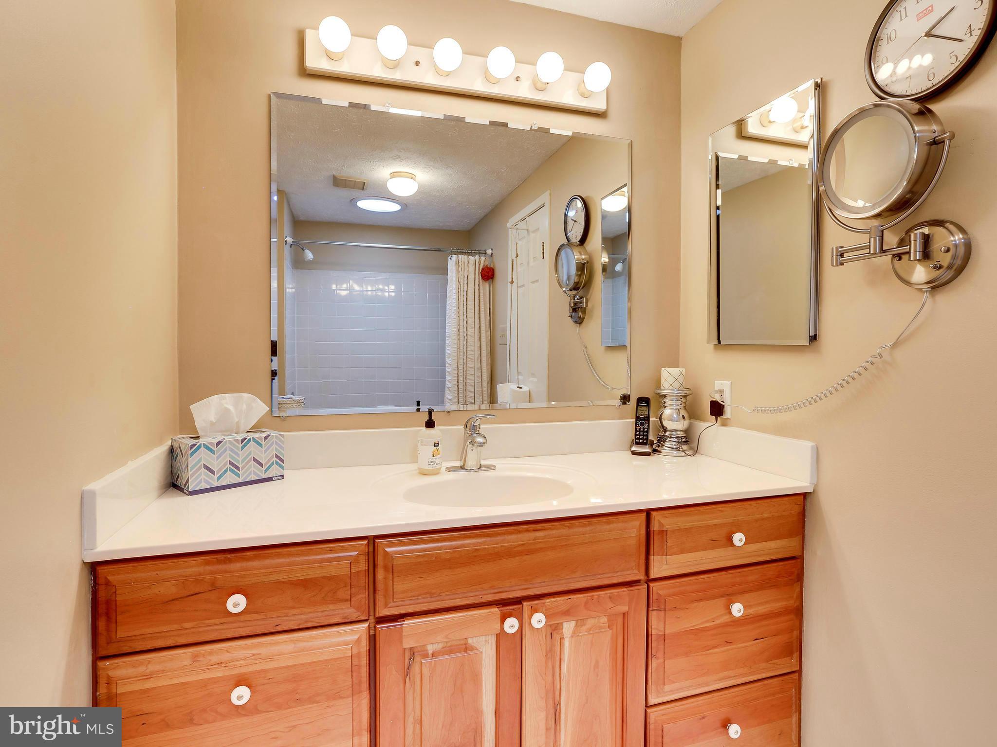 7569 Vogels Way Springfield, VA 22153 - Photo 25 of 28 a bathroom with a granite countertop double vanity sink and a mirror