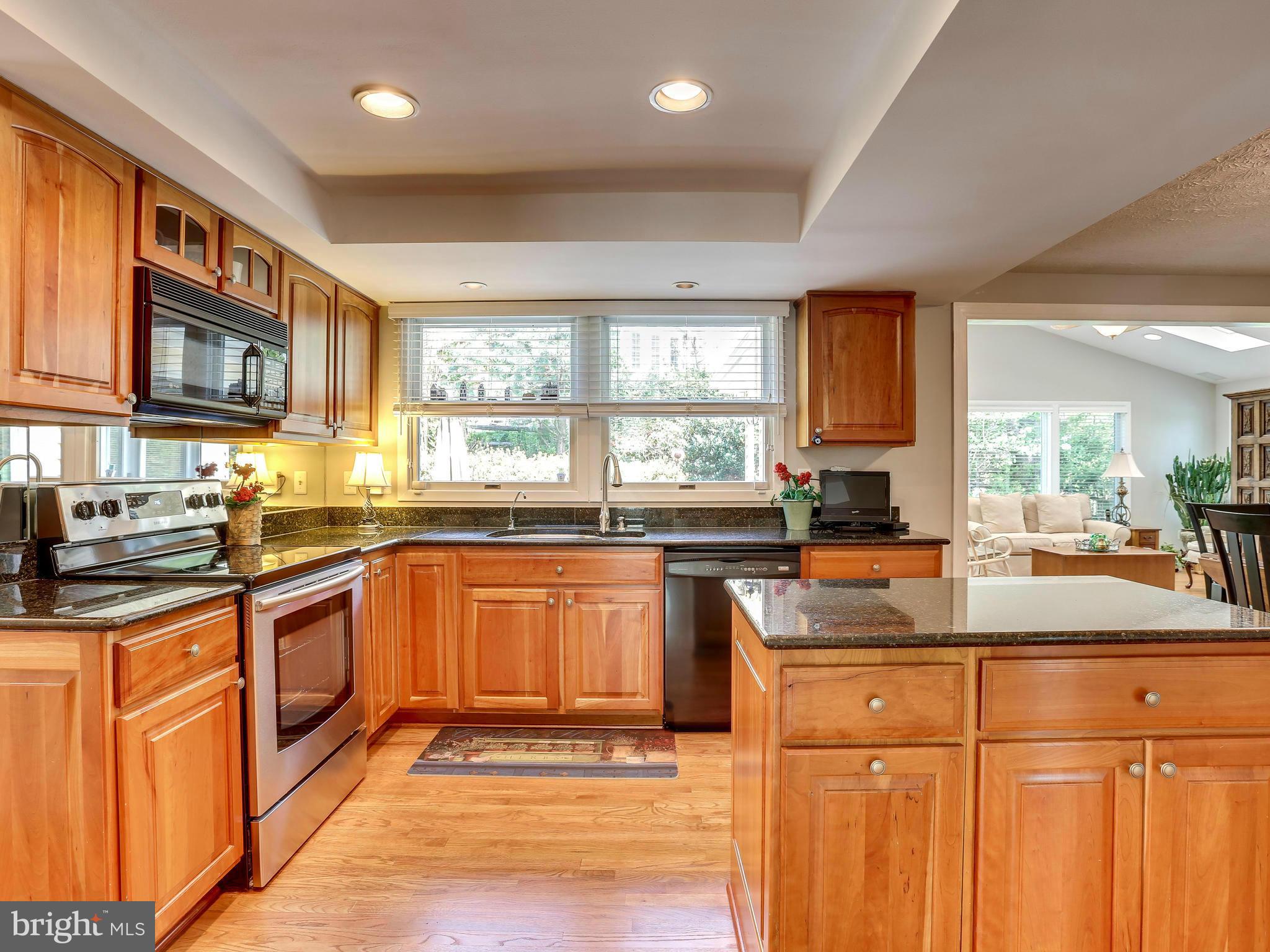 7569 Vogels Way Springfield, VA 22153 - Photo 4 of 28 a kitchen with stainless steel appliances granite countertop a stove a sink and a microwave