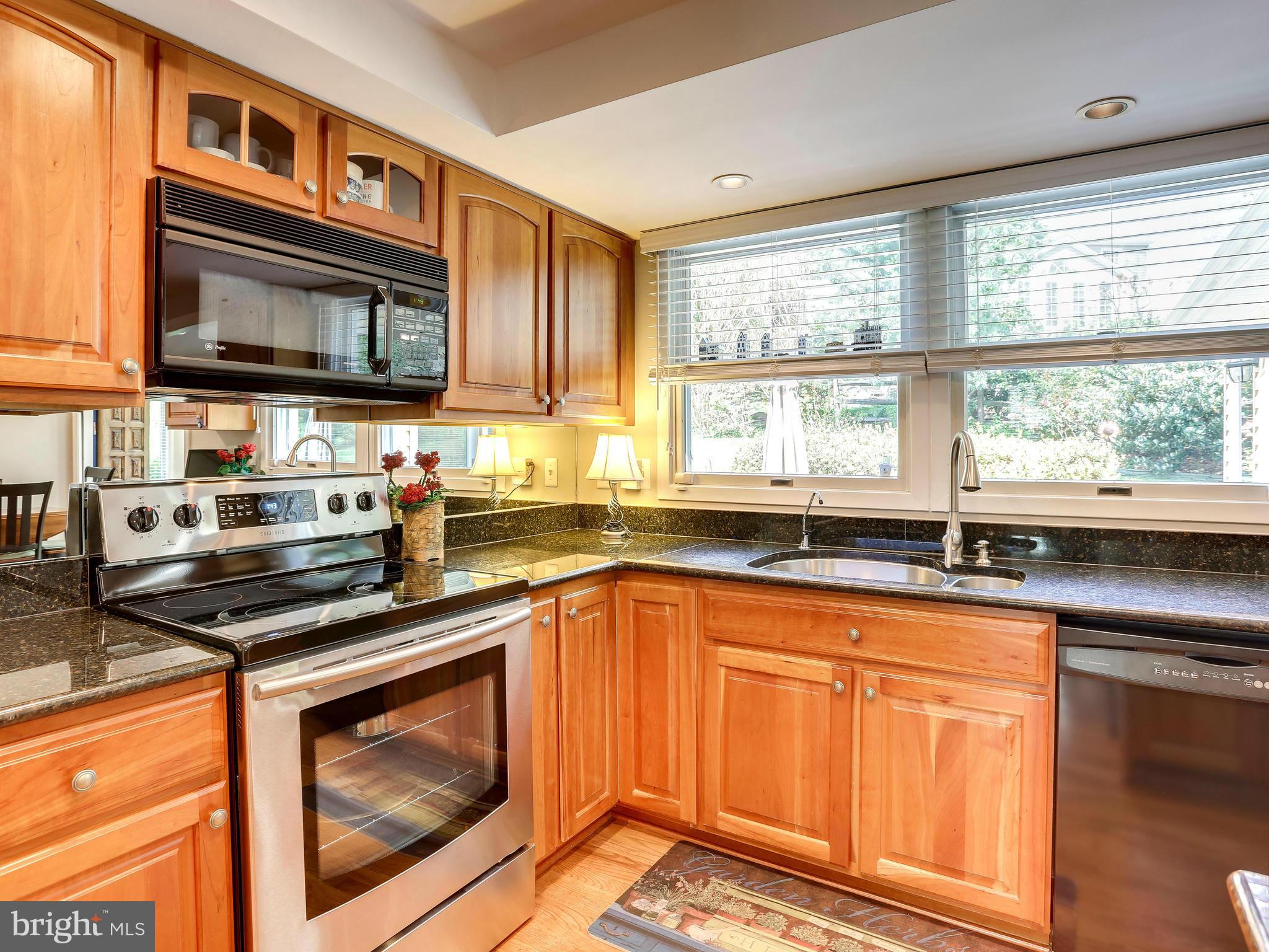 7569 Vogels Way Springfield, VA 22153 - Photo 5 of 28 a kitchen with stainless steel appliances granite countertop a stove sink and cabinets