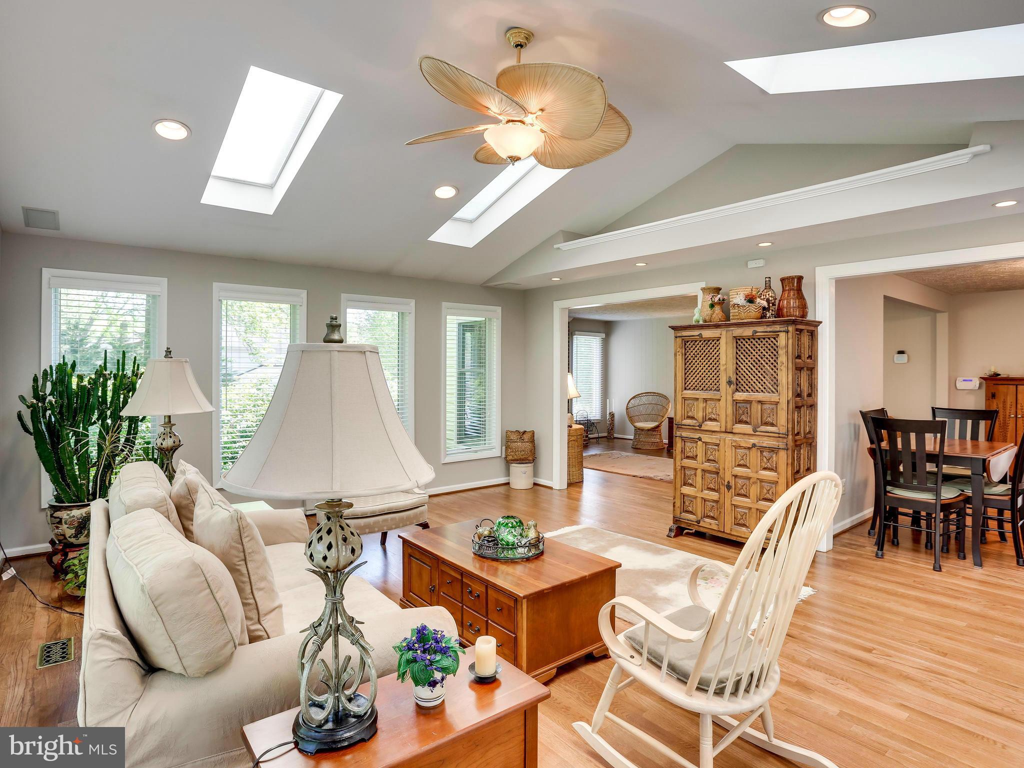7569 Vogels Way Springfield, VA 22153 - Photo 6 of 28 a living room with furniture a chandelier and a dining table