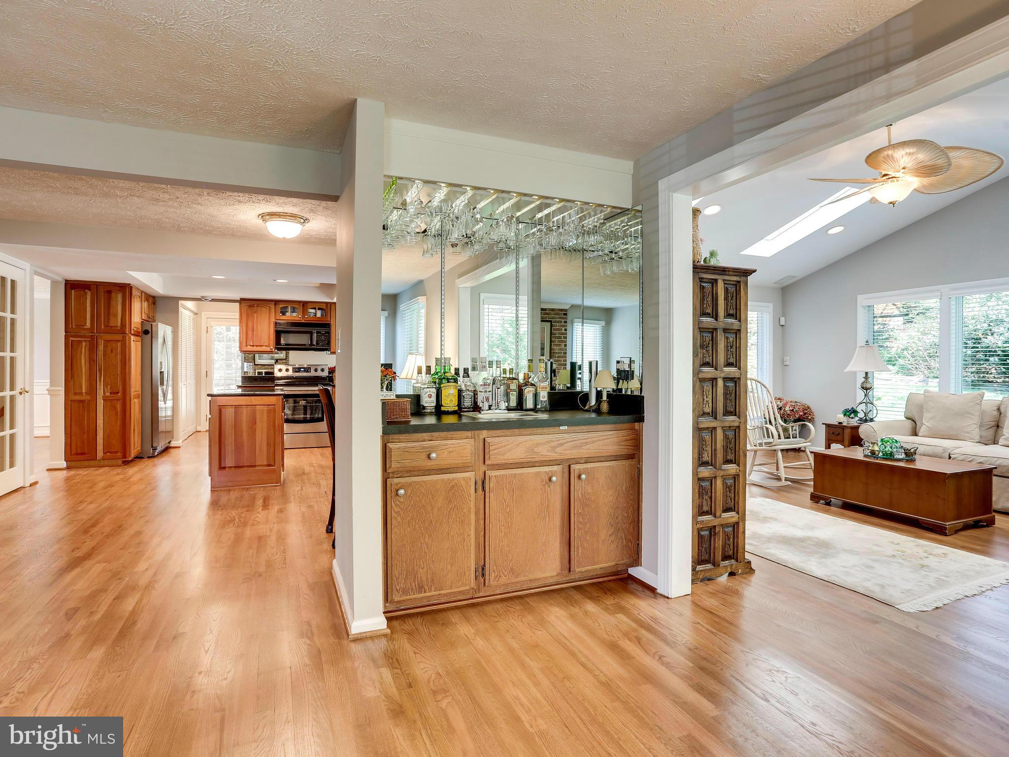 7569 Vogels Way Springfield, VA 22153 - Photo 10 of 28 a view of a living room kitchen with furniture and wooden floor