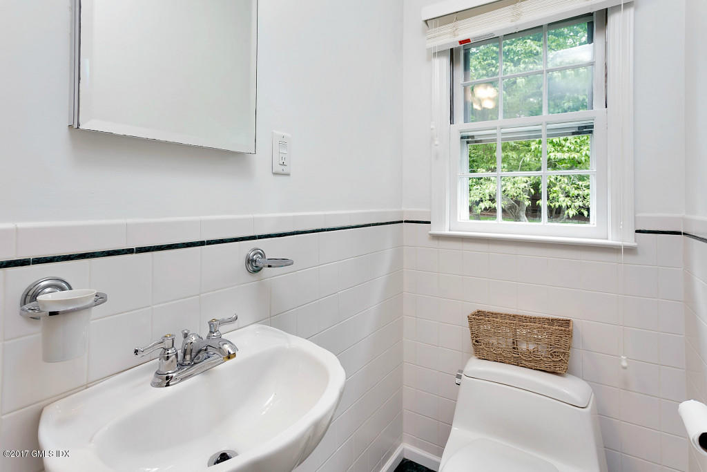 29 Long Meadow Road Riverside, CT 06878 - Photo 14 of 26 a bathroom with a sink a toilet and a mirror