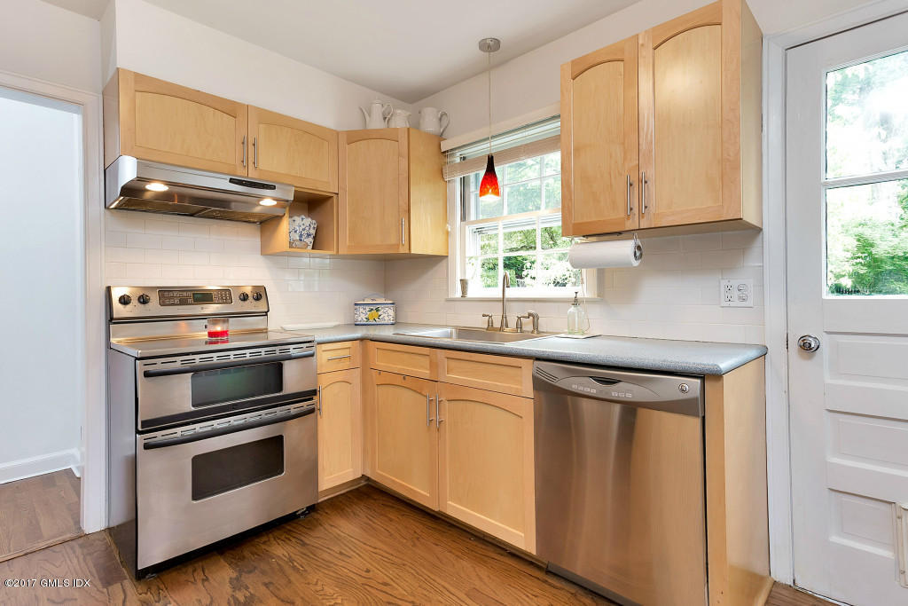 29 Long Meadow Road Riverside, CT 06878 - Photo 6 of 26 a kitchen with stainless steel appliances a stove a sink and cabinets