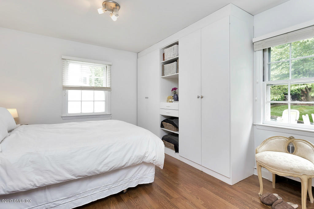 29 Long Meadow Road Riverside, CT 06878 - Photo 9 of 26 a bedroom with a bed and a window with chair