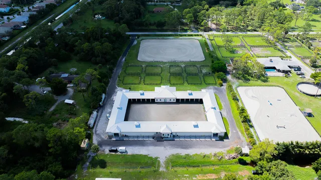an aerial view of a house with outdoor space pool seating area and yard