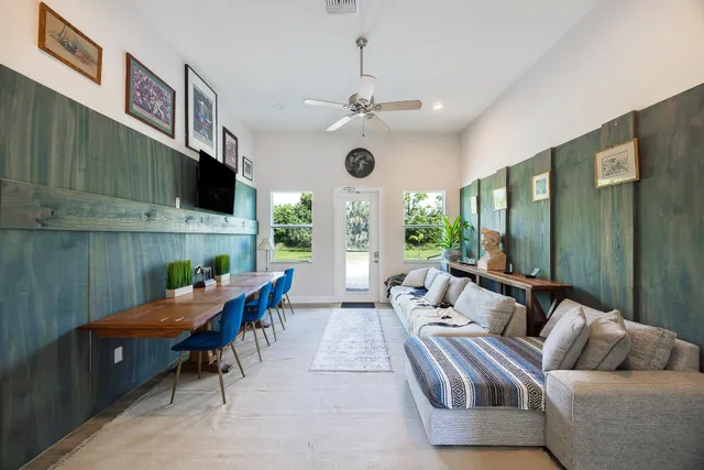 a living room with furniture fireplace and a large window
