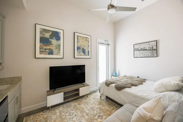 a bedroom with a bed and a flat screen tv