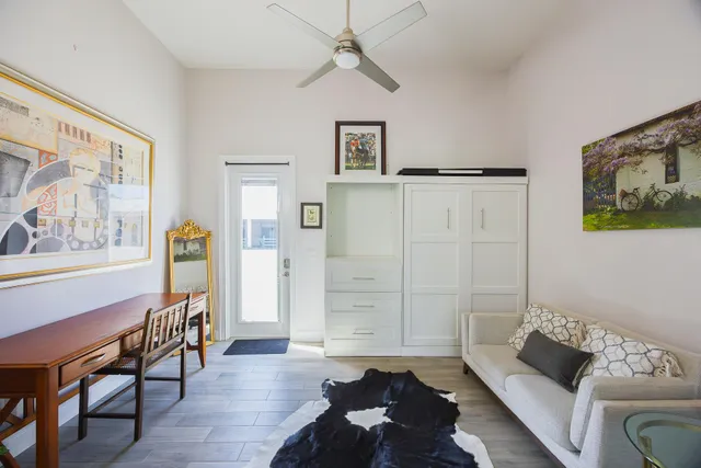 a living room with furniture and wooden floor