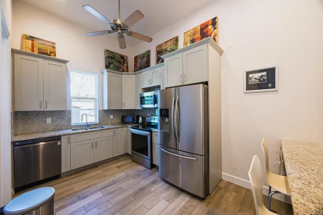 a kitchen with stainless steel appliances a refrigerator and a stove