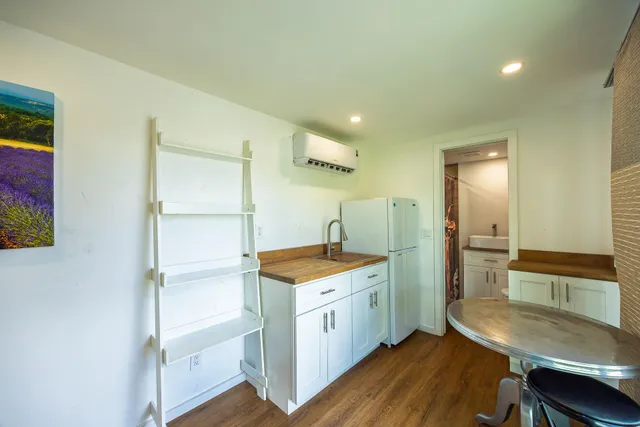 a kitchen with a stove and white cabinets