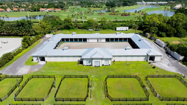 an aerial view of a house with outdoor space pool patio and lake view