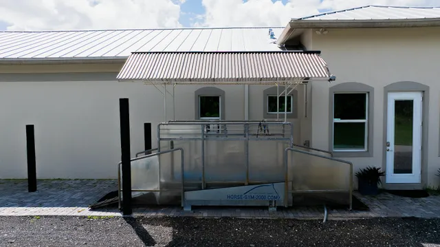 a view of a patio with table and chairs with wooden fence