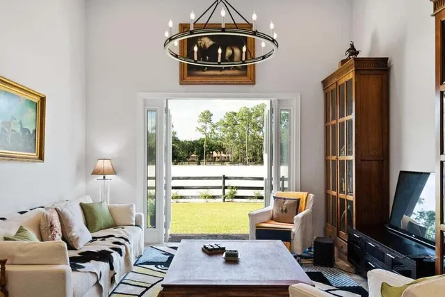 a living room with furniture and a floor to ceiling window