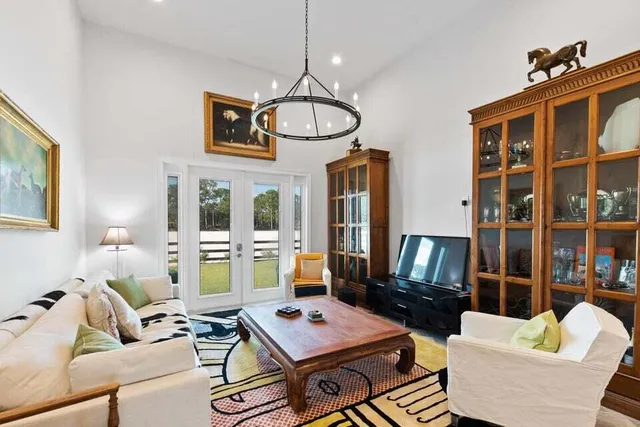 a living room with furniture and floor to ceiling windows