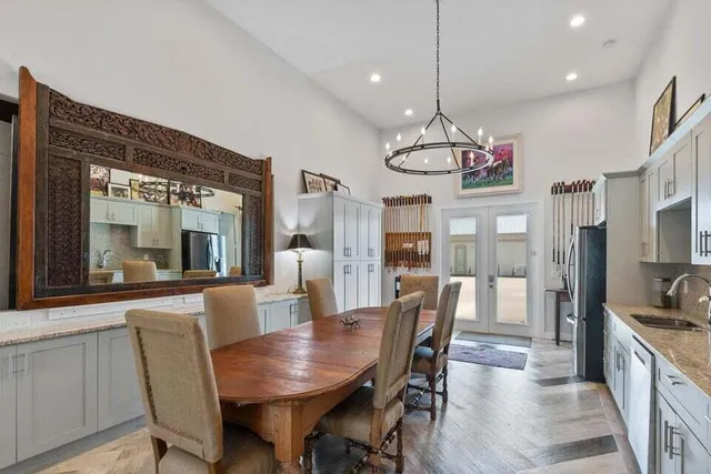 a view of a dining room with furniture large window and wooden floor