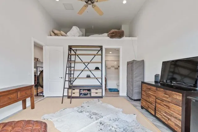 a bedroom with furniture and natural light