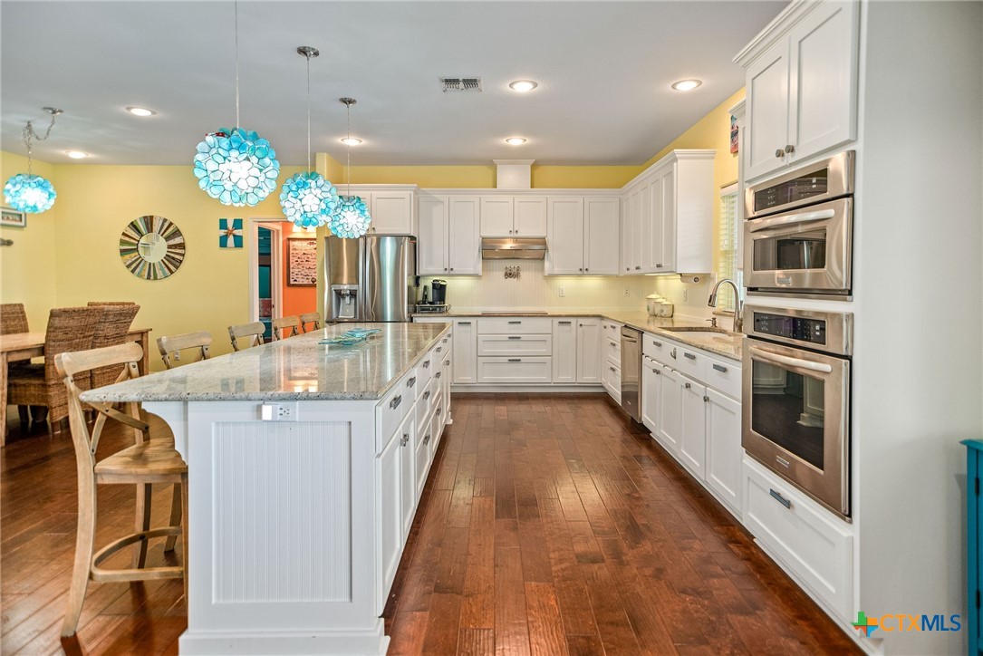 23 Macey Street Port O'Connor, TX 77982 - Photo 22 of 47 a kitchen with cabinets a sink and appliances