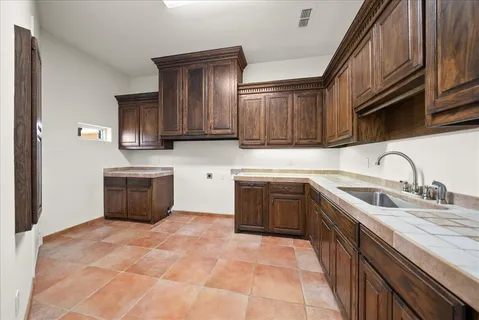 a bathroom with a sink a toilet and mirror