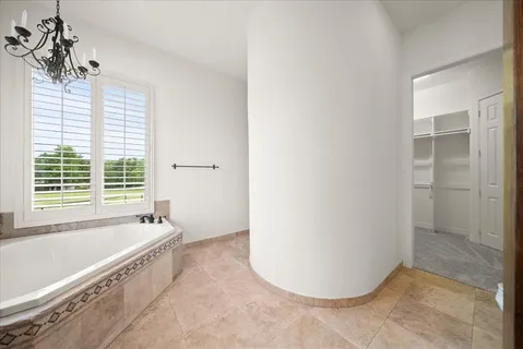 a bathroom with a tub a sink and a shower
