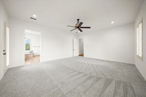 a view of a livingroom with a ceiling fan and window