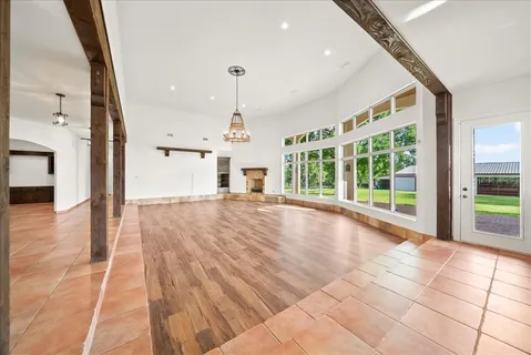 a large kitchen with stainless steel appliances a large counter top a stove and a refrigerator