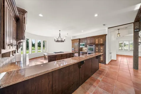a kitchen with a stove a sink and a refrigerator
