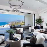 a living room with furniture a chandelier and a fireplace