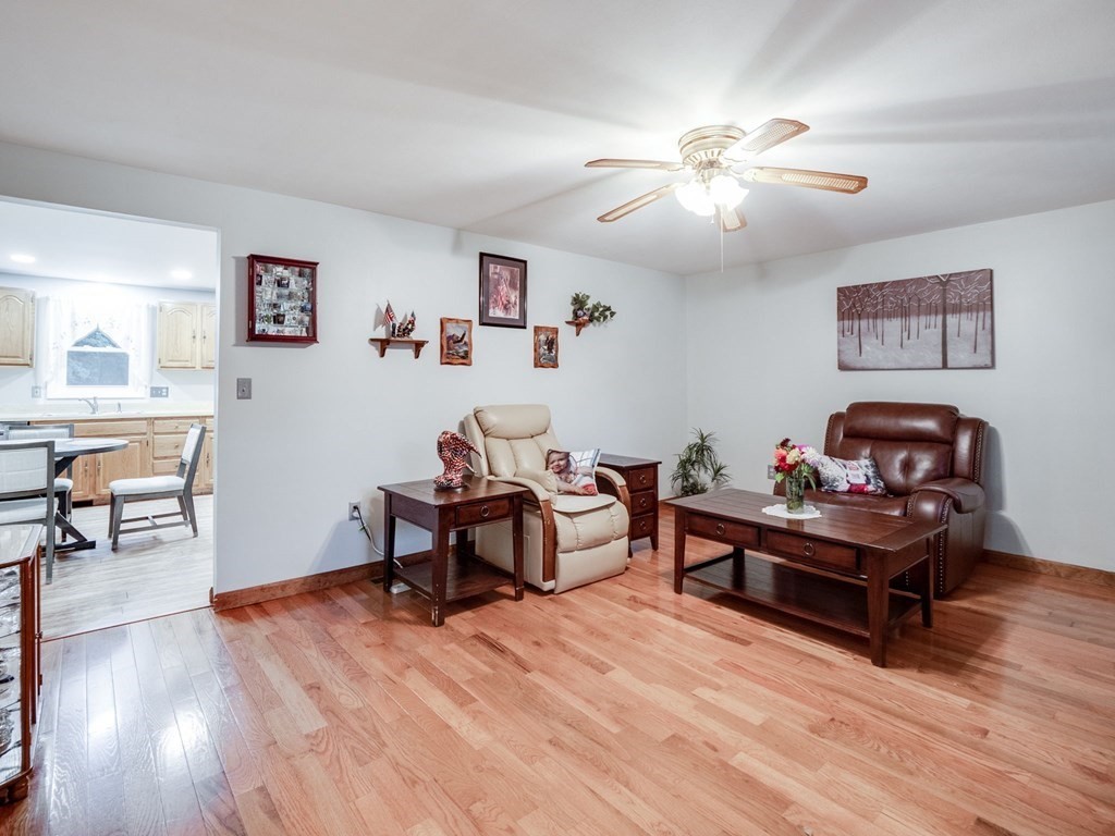 145 Coburn Road Tyngsborough, MA 01879 - Photo 15 of 41 a living room with furniture and a wooden floor