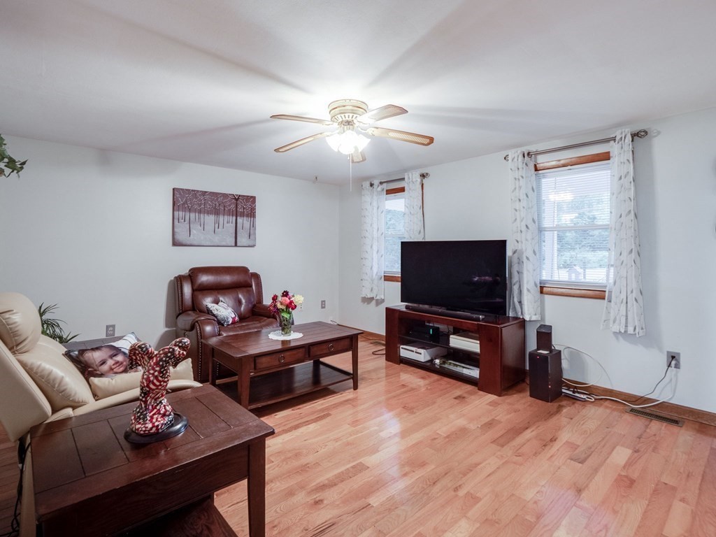 145 Coburn Road Tyngsborough, MA 01879 - Photo 16 of 41 a living room with furniture and a flat screen tv