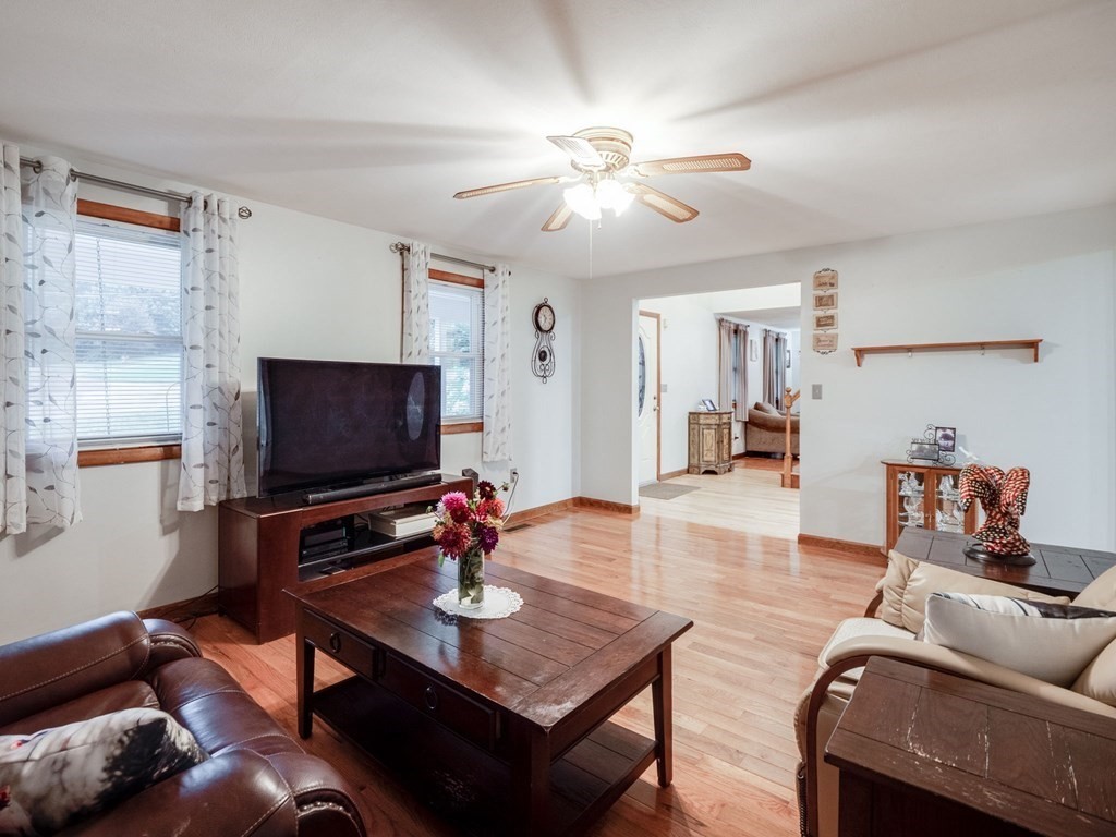145 Coburn Road Tyngsborough, MA 01879 - Photo 18 of 41 a living room with furniture and a flat screen tv