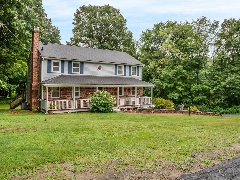 145 Coburn Road Tyngsborough, MA 01879 - Photo 2 of 41 a front view of a house with a garden