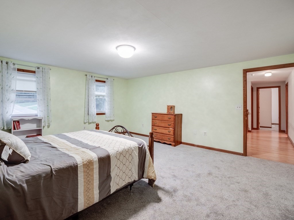 145 Coburn Road Tyngsborough, MA 01879 - Photo 21 of 41 a spacious bedroom with a bed and a cabinets