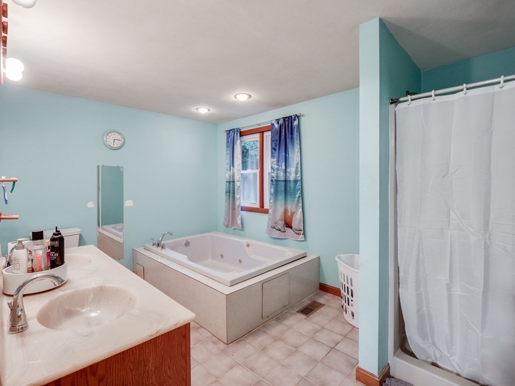 145 Coburn Road Tyngsborough, MA 01879 - Photo 22 of 41 a bathroom with 2 sink tub and a mirror