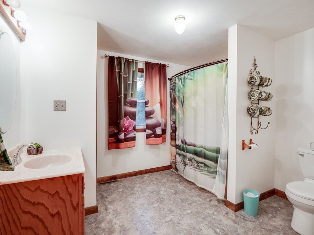 145 Coburn Road Tyngsborough, MA 01879 - Photo 23 of 41 a view of a bedroom with baby crib and toys