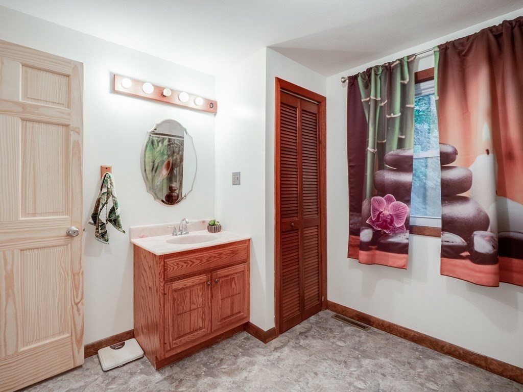 145 Coburn Road Tyngsborough, MA 01879 - Photo 24 of 41 a bedroom with a bed and a mirror on the dresser