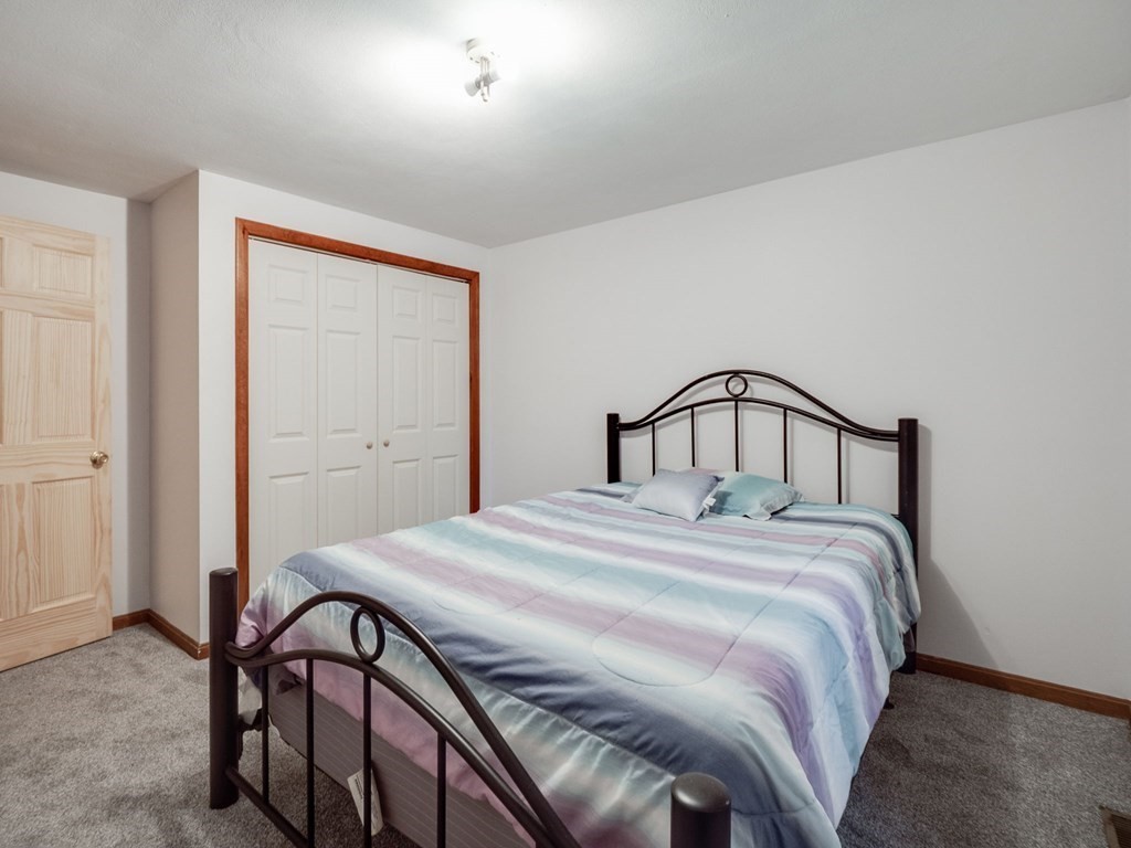 145 Coburn Road Tyngsborough, MA 01879 - Photo 26 of 41 a bedroom with a bed and a mirror