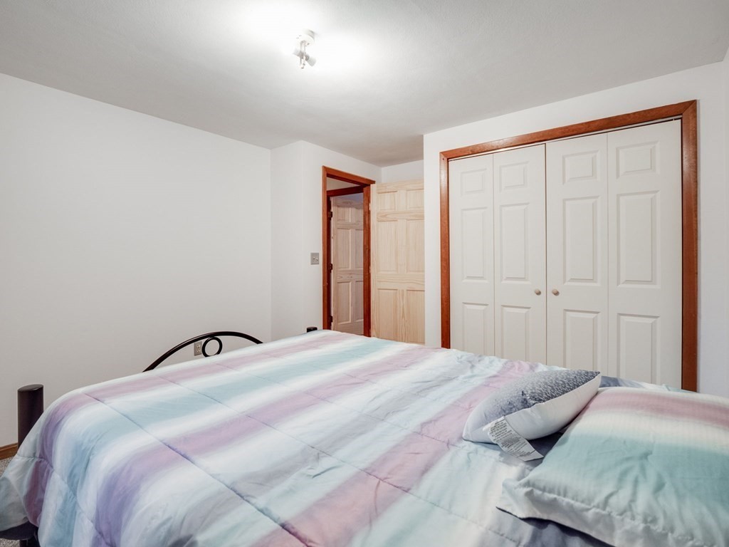 145 Coburn Road Tyngsborough, MA 01879 - Photo 27 of 41 a bedroom with a bed and window