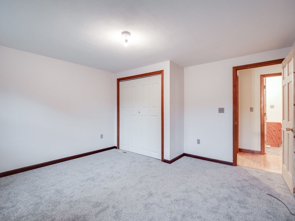 145 Coburn Road Tyngsborough, MA 01879 - Photo 28 of 41 an empty room with closet and windows