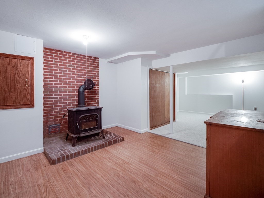 145 Coburn Road Tyngsborough, MA 01879 - Photo 29 of 41 a living room with a furniture and a fireplace