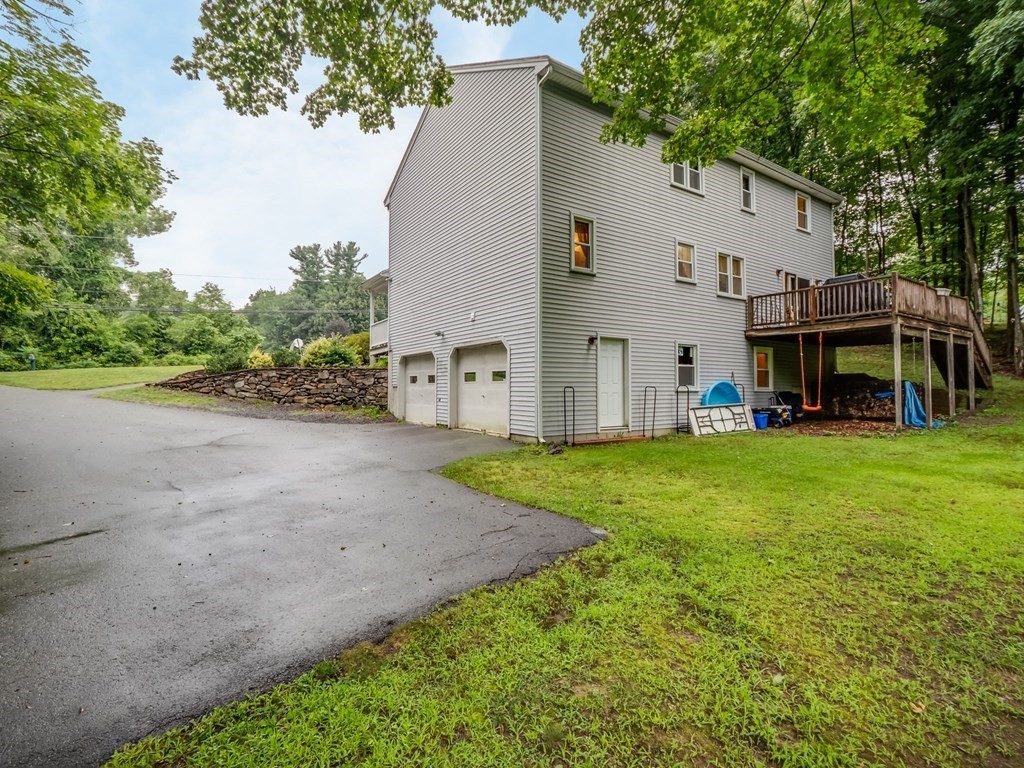 145 Coburn Road Tyngsborough, MA 01879 - Photo 35 of 41 a view of a white house with a big yard and large tree